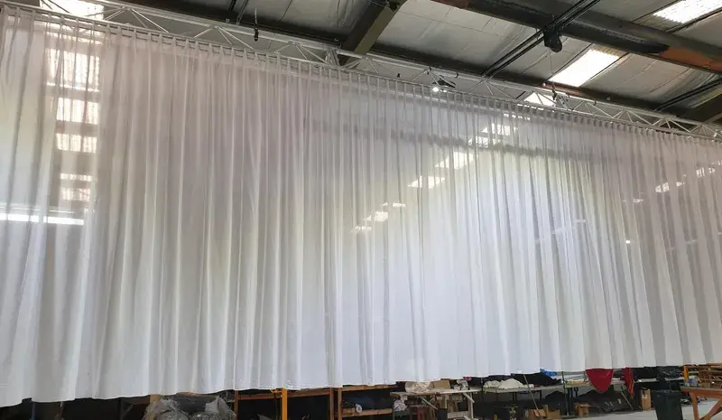 White sheer voile drapes finished with a sewn-in S Wave heading