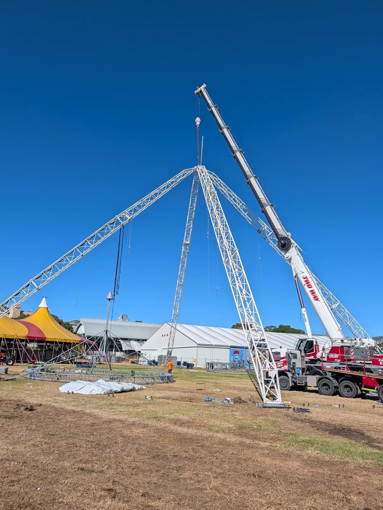 The Come Alive tent and stage masts going up on site during load-in