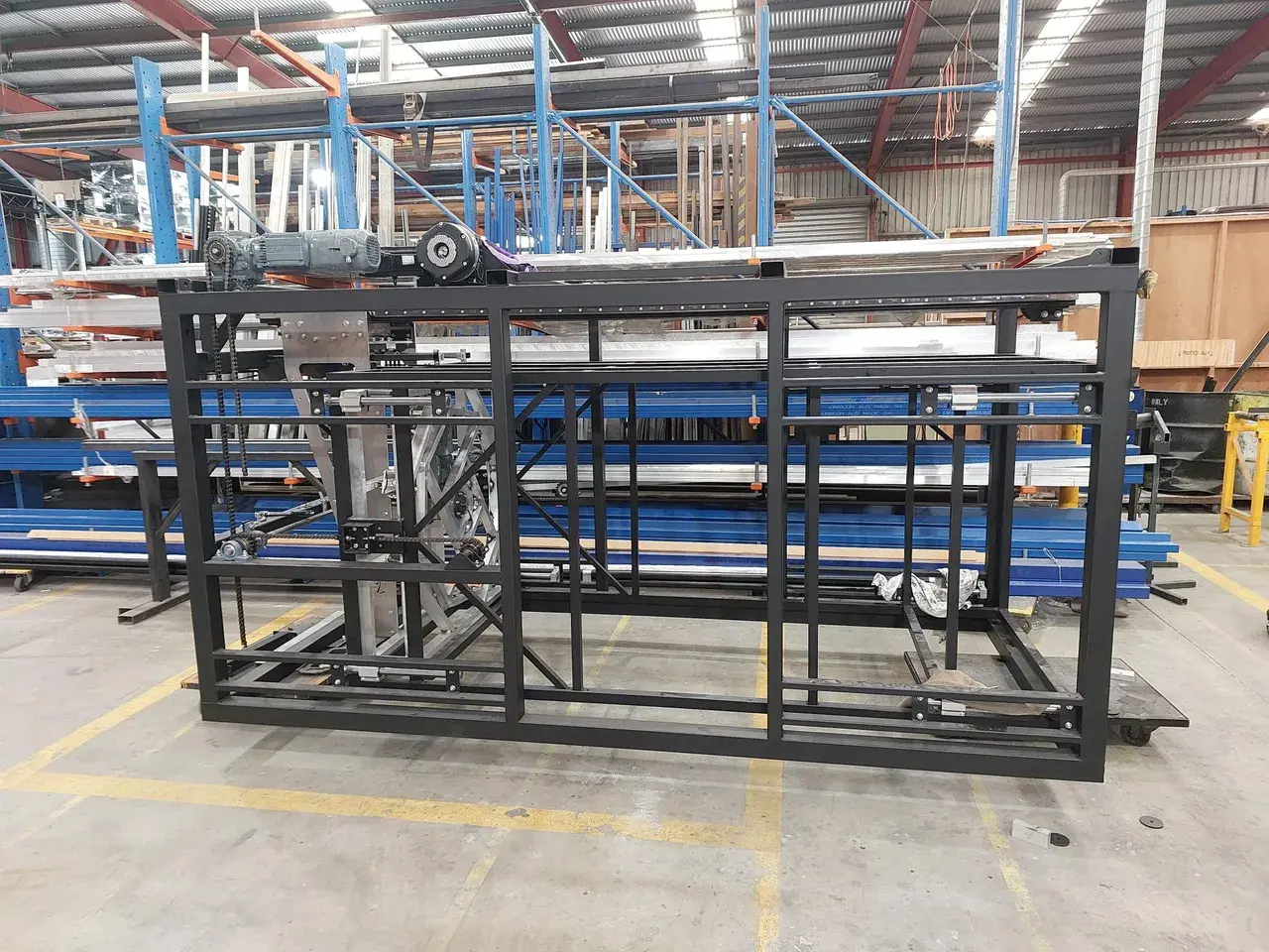 The toaster lift chassis on the TSA workshop floor - servo, belt drive and steel frame assembled in-house