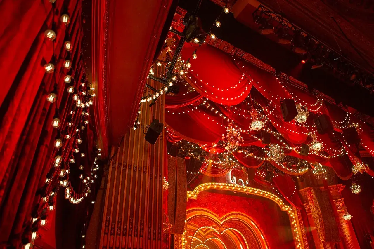 Layered red, blue and gold Moulin Rouge stage drapes used in set dressing. Photo: Chris Parker.