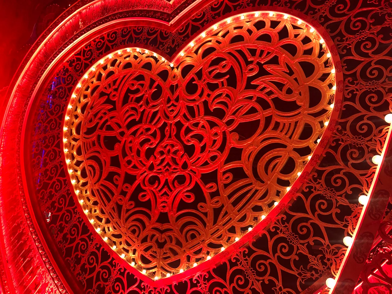 Finished heart portal with gold filigree scrollwork, lit